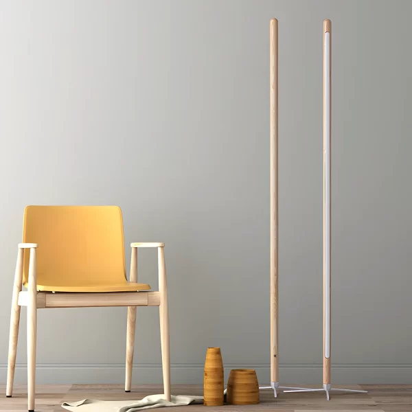 Two ash wood floor lamps, one facing forward and one backward, are placed to the right of a yellow chair.