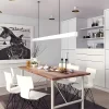 A white pendant light hangs from the ceiling above a square wooden dining table in a modern-style home.