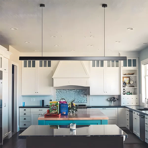 A black pendant light hangs from the ceiling above a European-style kitchen island