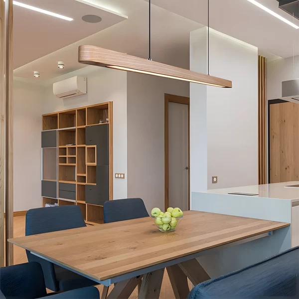 In a modern-style home, an oval linear LED ash pendant light hangs from the ceiling above the dining table.