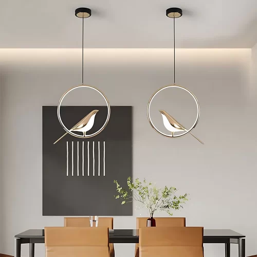 Round Gold Creative Magpie Bird Rotatable LED Chandelier hangs from the ceiling above the dinner table.