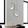 Round Black Creative Magpie Bird Rotatable LED Chandelier hangs from the ceiling above the meeting table.