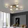 Gold 8 Heads Modern Aluminum Rings Frame LED Ceiling Pendant hangs from the living room's ceiling.