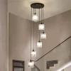 Round Modern Crystal Chandelier hangs above the ceiling at the staircase, emitting a warm and cozy glow