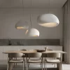 Wabi Sabi Minimalist Style Pendant Light hangs elegantly above the kitchen dining table, emitting a cozy and comfortable warm light.