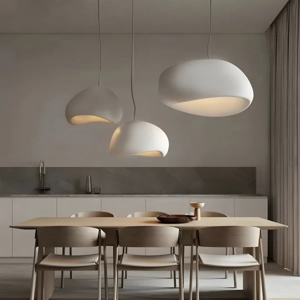 Wabi Sabi Minimalist Style Pendant Light hangs elegantly above the kitchen dining table, emitting a cozy and comfortable warm light.