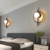 Two Black Circular Acrylic Wall Lamps are installed on both sides of the bedroom bed