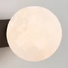 Close up of Modern Minimalist Creative Moon Wall Lamp, showcased the lunar lampshade.