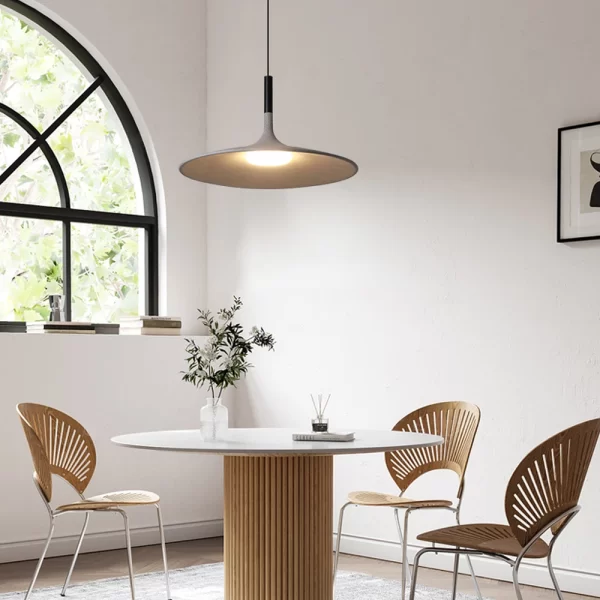 Industrial LED Cement Pendant Lights that emits a warm glow hangs elegantly from the ceiling in the corner of the living room.