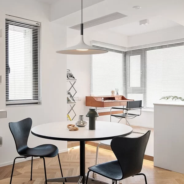 Industrial LED Cement Pendant Lights that emit a warm glow hang from the ceiling in the white decor-style house.