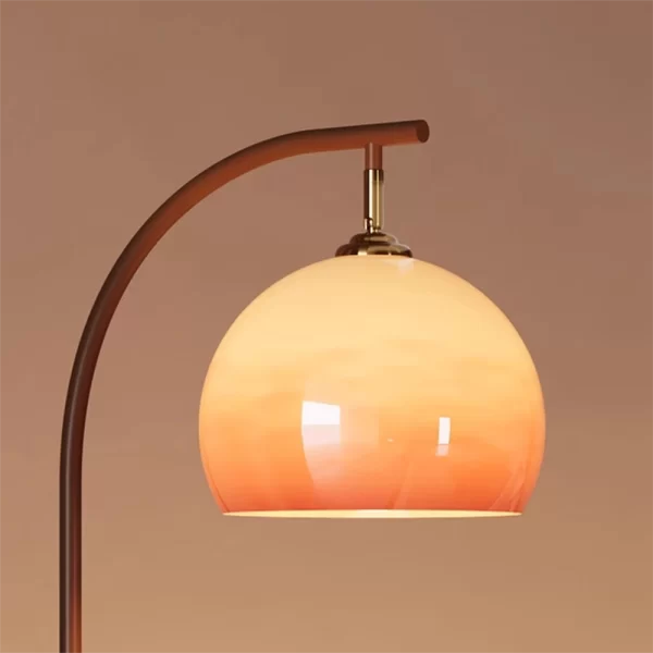 Close up of Retro Tall Pole Arc Floor Lamp, displaying the orange glass lampshade.